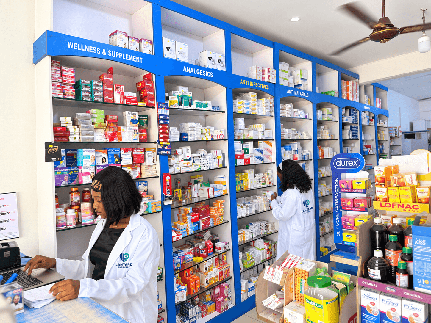 Lanyard pharmacists serving customers in the pharmacy